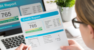 A person holding a credit report that shows a good credit score you can build.